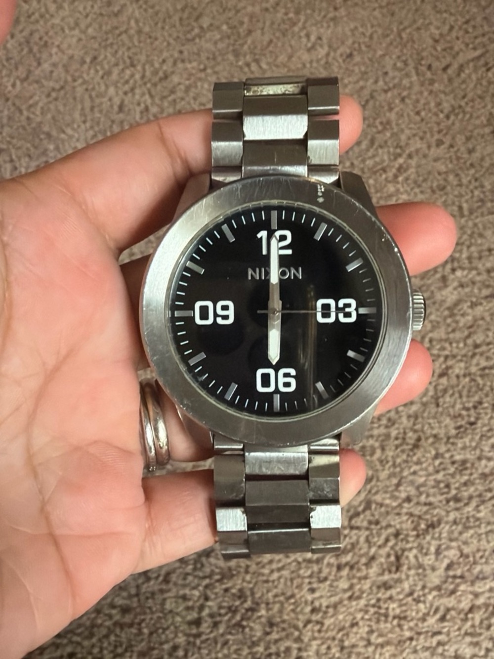 Nixon Silver Stainless Steel Watch with Black Dial. Nixon take charge.